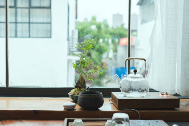 istock Green plants and tea sets on the windowsill. 1969416986