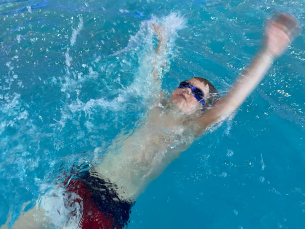menino alegre nadando na piscina - mobilestock freedom enjoyment blue - fotografias e filmes do acervo