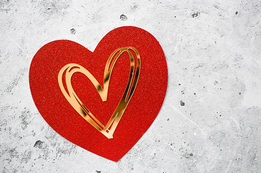 Festive background with red and gold hearts on a gray concrete background. valentine's day. Love.