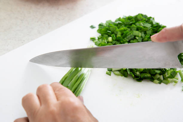 Cooking scene, cutting chives, chopping salmon