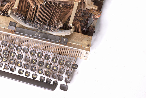 Broken metal typewriter, vintage object isolated, full frame