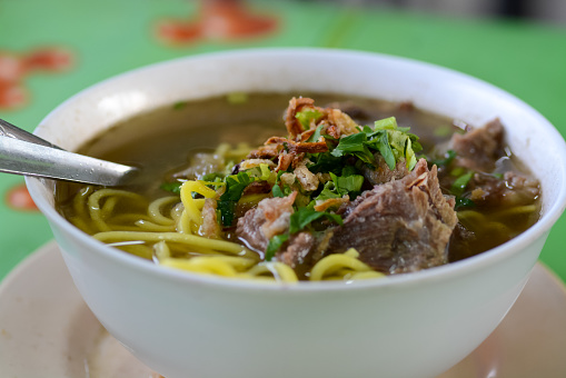 A popular Malaysian dish, this bowl features Chinese noodles immersed in a flavorful Asian soup with meat