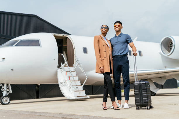istock Full length diverse passengers arriving to destination by private mid size jet. wealthy entrepreneurs using private airplane. 1969468373