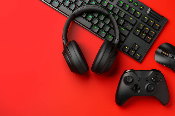 istock Computer keyboard and headphones on red background top view 1969472102