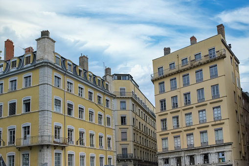 The beautiful buildings of Lyon, France against the blue cloudy sky