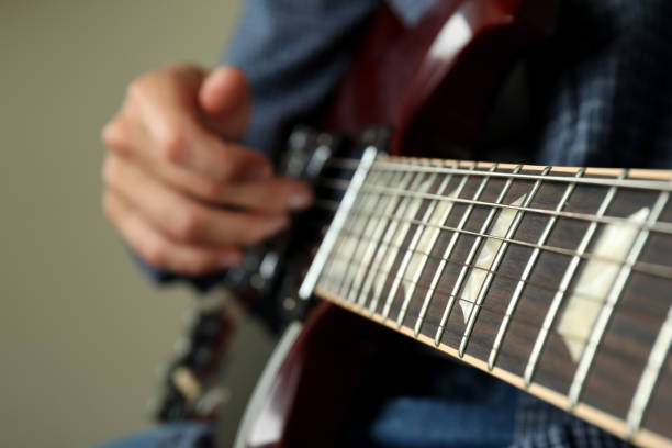 Detailed acoustic guitar focusing on the strings and body. Wooden guitar neck with the strings visible