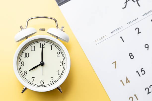 istock Calendar and alarm clock on a yellow background. 1969493835