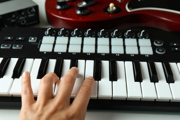 istock Female hand playing on midi keyboard, close up 1969496538