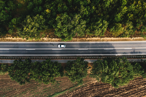 Automobile on highway road, top view aerial shot from drone pov, directly above
