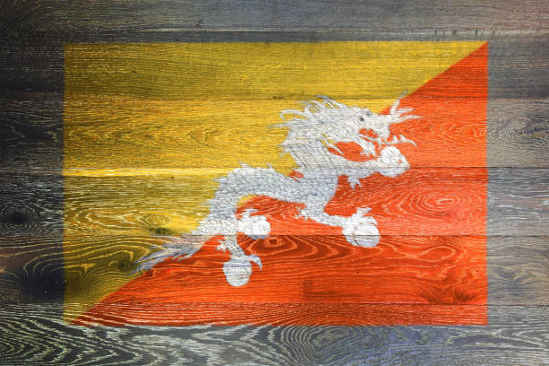 Bhutan flag on rustic old wood surface background yellow orange diagonal Druk Thander Dragon