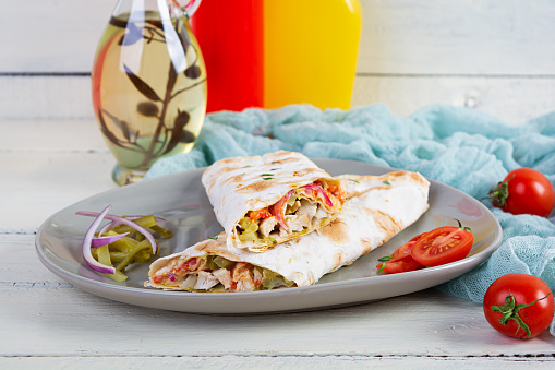 Delicious grilled chicken shawarma sandwich. Wraped in lavash doner kebab