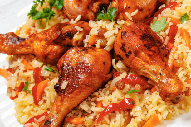 istock fried chicken drumsticks over rice pilaf, top view 1969536039