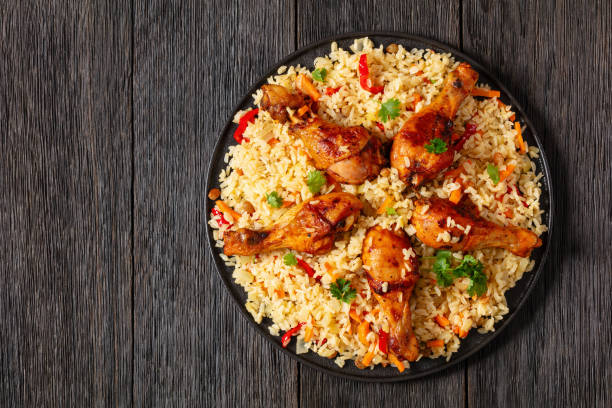 istock fried chicken drumsticks over rice pilaf, top view 1969536709