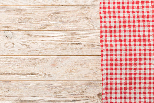 top view with red empty kitchen napkin isolated on table background. Folded cloth for mockup with copy space, Flat lay. Minimal style.