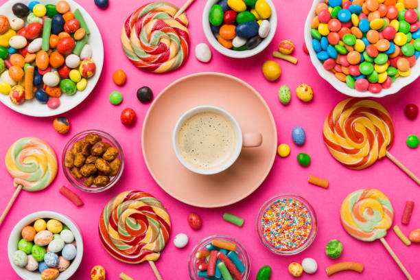 istock Coffee cup with chocolates and colored candy. Top view on table background with copy space 1969542068