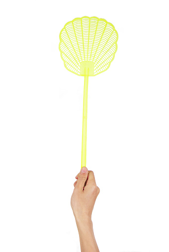 A fly swatter being used by a man's hand.