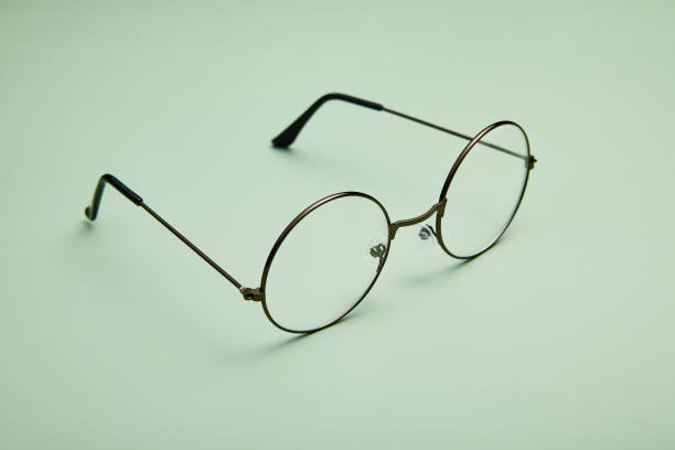 istock Open metal rimmed spectacles isolated on light-green. 1969545046