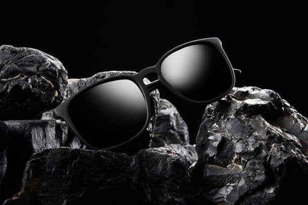 open sunglasses, sun shades in plastic frame is on stones. - sun blind photos et images de collection