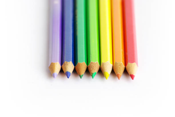 A row of colored pencils sitting next to each other