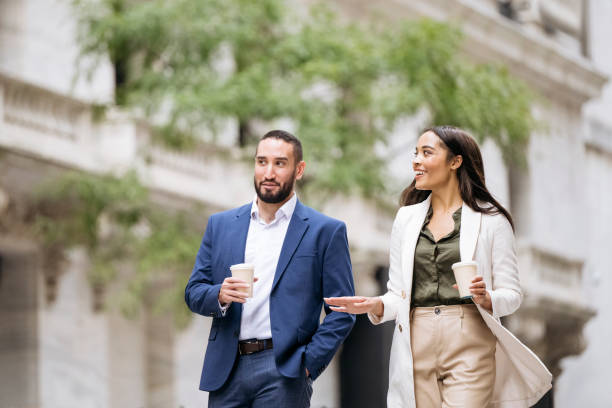 istock Confident business colleagues walking outdoors with coffee 1969565502