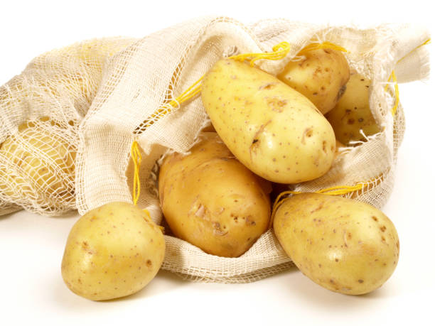 istock New Potatoes in a Bag on white Background 1969577645