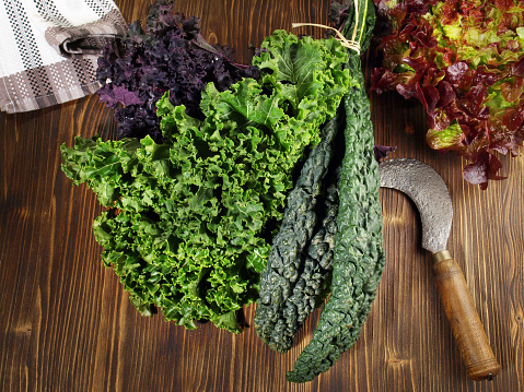 Various Kale Leaves with Lettuce on wooden Background