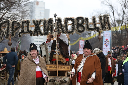 Pernik, Bulgaria - January 27, 2024: The 30th International masquerade festival Surva in Pernik, Bulgaria. People with mask called Kukeri dance and perform to scare the evil spirits.