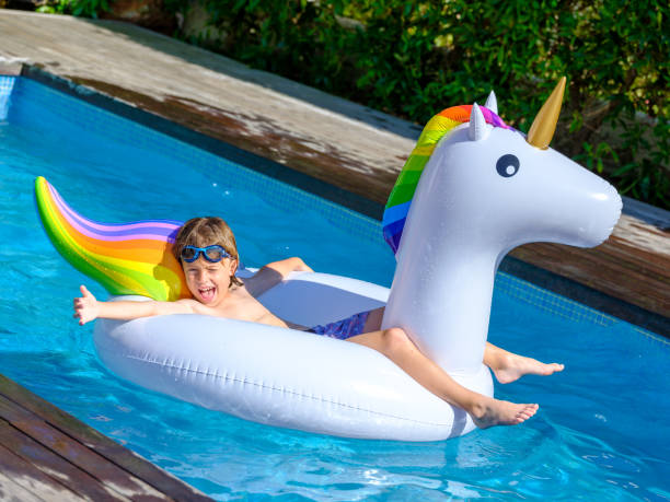 istock Cute kid recreating in pool lying on inflatable ring 1969591302