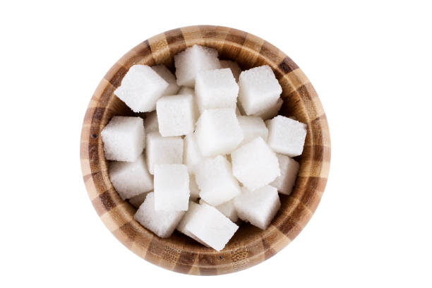 istock Wooden bowl with white sugar cubes isolated on white background 1969596655