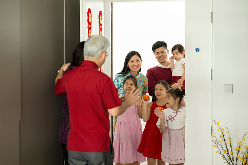 Young Chinese family visiting parents during Chinese New Year