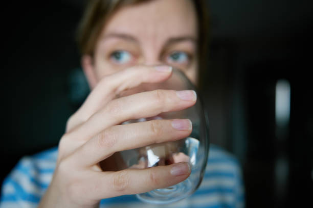 Woman drinks water, Close-up shot of woman drinking fresh clean water from glass, Quenching thirst, Lifestyle healthcare concept