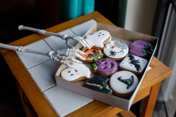 istock Skeleton hands reaching for Halloween themed cookies 1969624901
