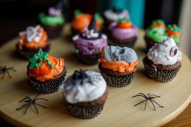 istock Cute Halloween themed cupcakes served on a wooden plate 1969624996