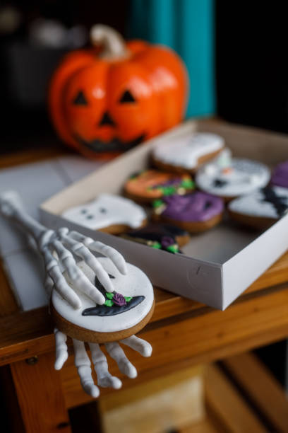 istock Fake skeleton hands holding Halloween themed cookies 1969625069