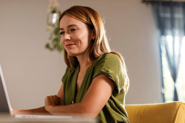 istock Woman using laptop when working from home office 1969628115