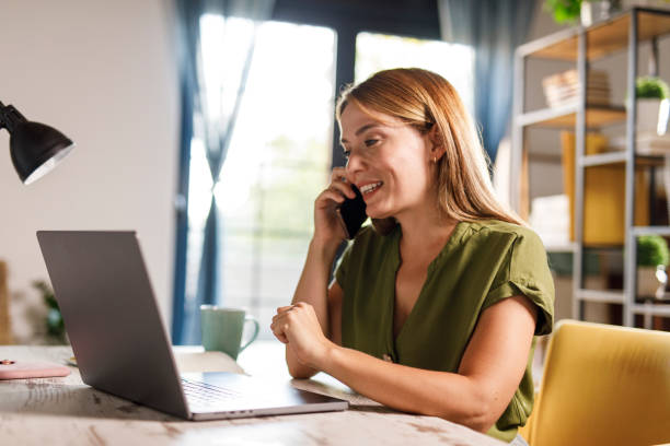 istock Charming woman working at home office desk, having a conference call 1969629197