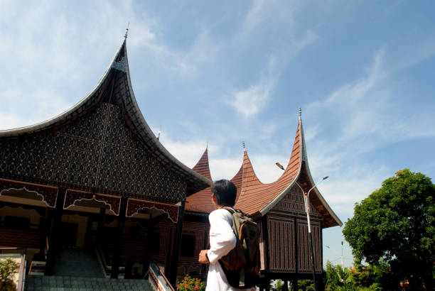 Panguruan, North Sumatra, Indonesia - January 31th 2024:  Row of houses with a typical Batak roofs in a village which specialize in selling homemade scarfs to the tourists