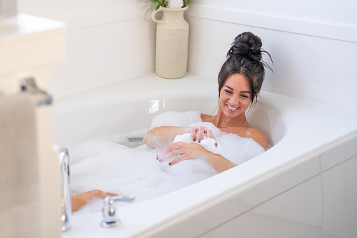 A woman enjoying a soothing bath.
