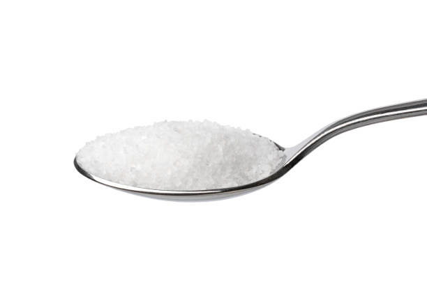 istock Metal spoon with a sea salt on white background 1969707754