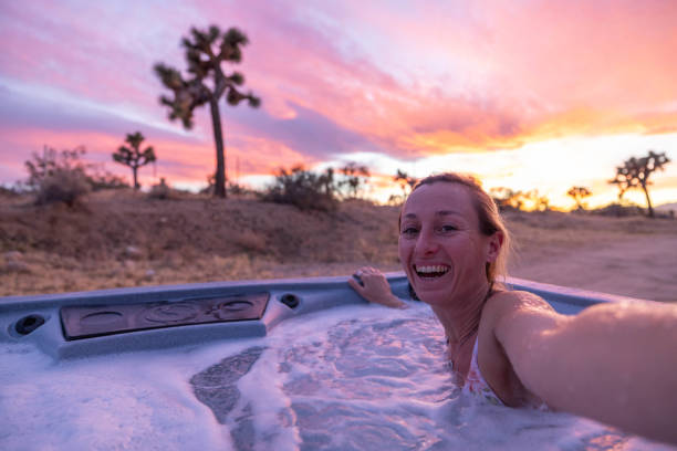 istock Desert Selfie Bliss: Woman in hot tub Capturing Serenity under a Dramatic Sunset Sky 1969709862