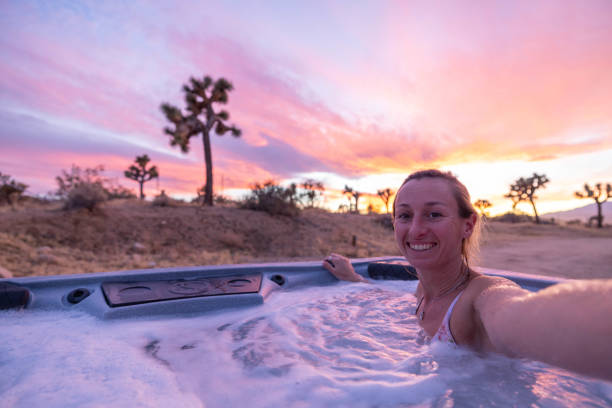 istock Desert Selfie Bliss: Woman in hot tub Capturing Serenity under a Dramatic Sunset Sky 1969709886