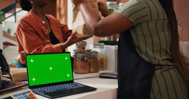 istock Merchant selling eco goods next to greenscreen laptop 1969711987