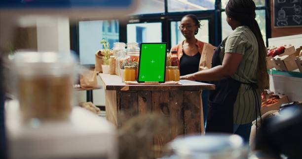 istock Merchant shows bio products next to greenscreen tablet 1969712536