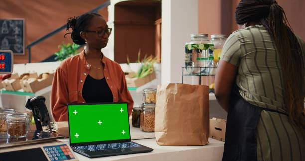 istock Retailer having laptop that shows greenscreen on display 1969718679