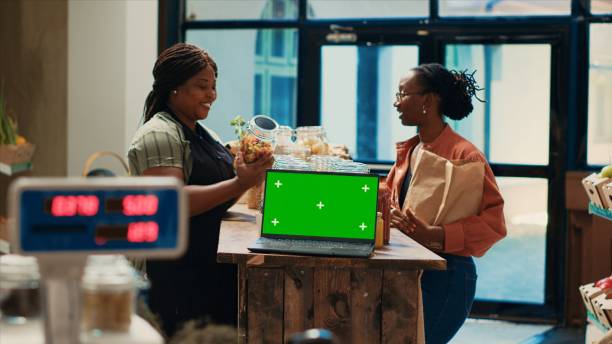 istock Seller presenting her merchandise next to greenscreen on pc 1969723339