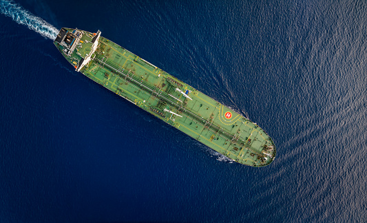 Aerial top down view of a large crude oil or chemical goods tanker sailing over the ocean