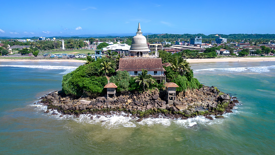 A beautiful temple on the shores of the Indian Ocean in the city of Matara, Sri Lanka. View from above