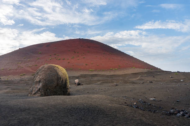 A lava bomb in Lanzarote near the Caldera colorada during a cloudy day