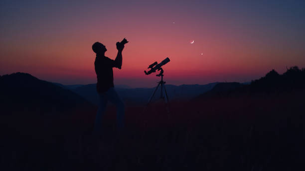 istock Astronomer with a camera photographing night skies. 1969802137