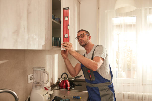 istock Handyman fixing kitchen cabinets in the apartment. 1969804246